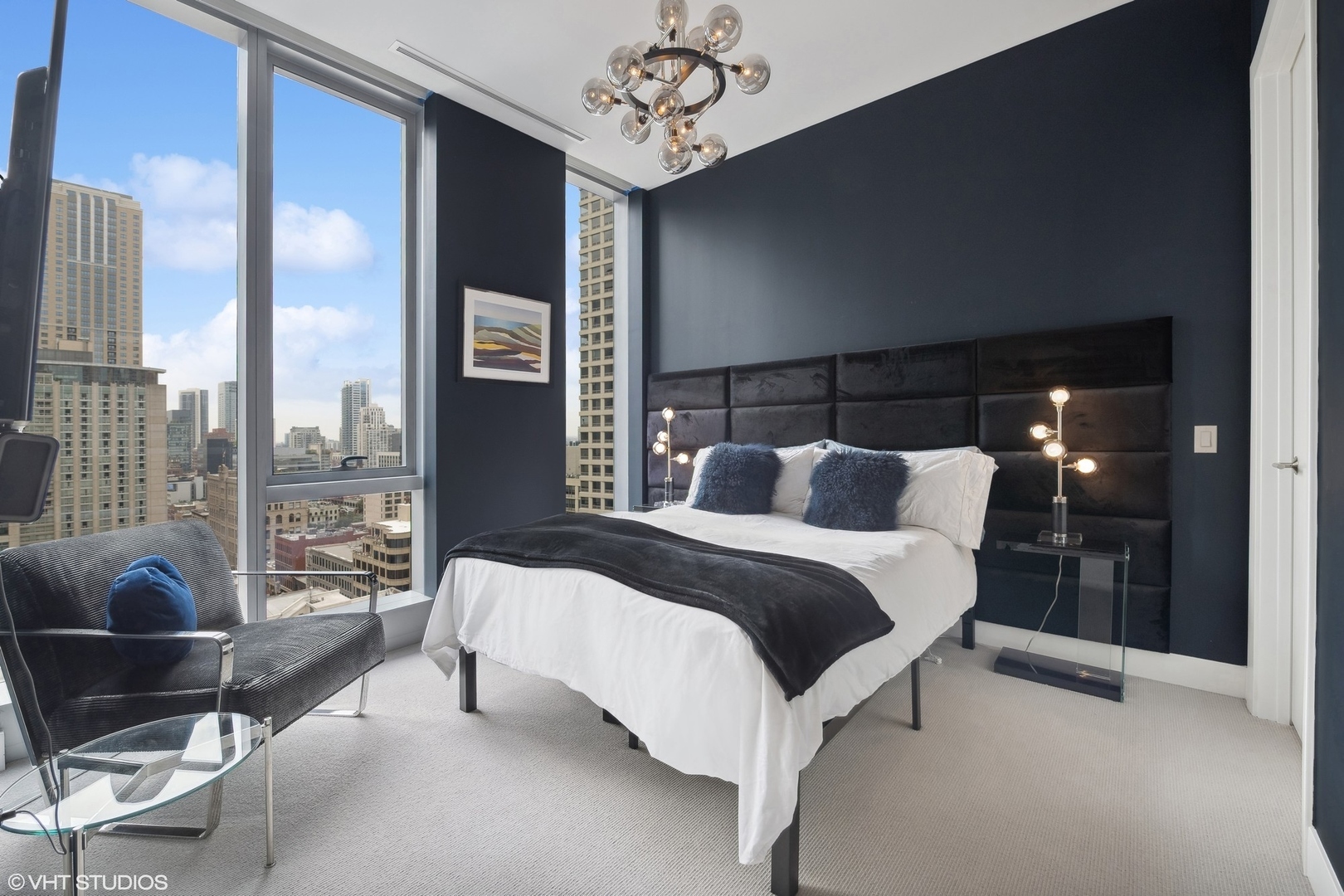 403 North Wabash Avenue, Unit 14A Chicago, IL 60611 - Photo 20 of 49 a spacious bedroom with a bed and glass walk in closet