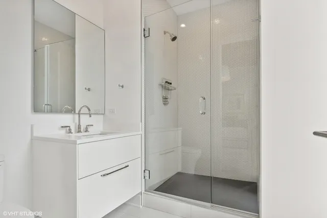 a bathroom with a shower sink and mirror
