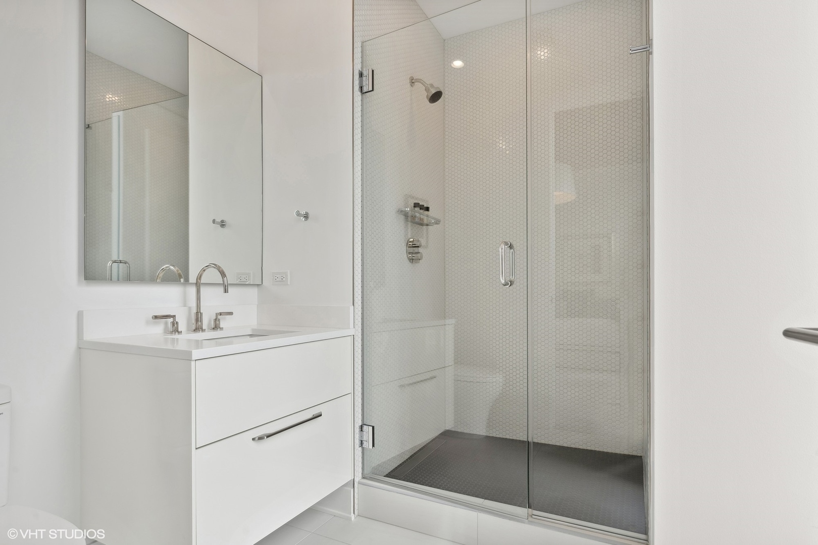 403 North Wabash Avenue, Unit 14A Chicago, IL 60611 - Photo 21 of 49 a bathroom with a shower sink and mirror
