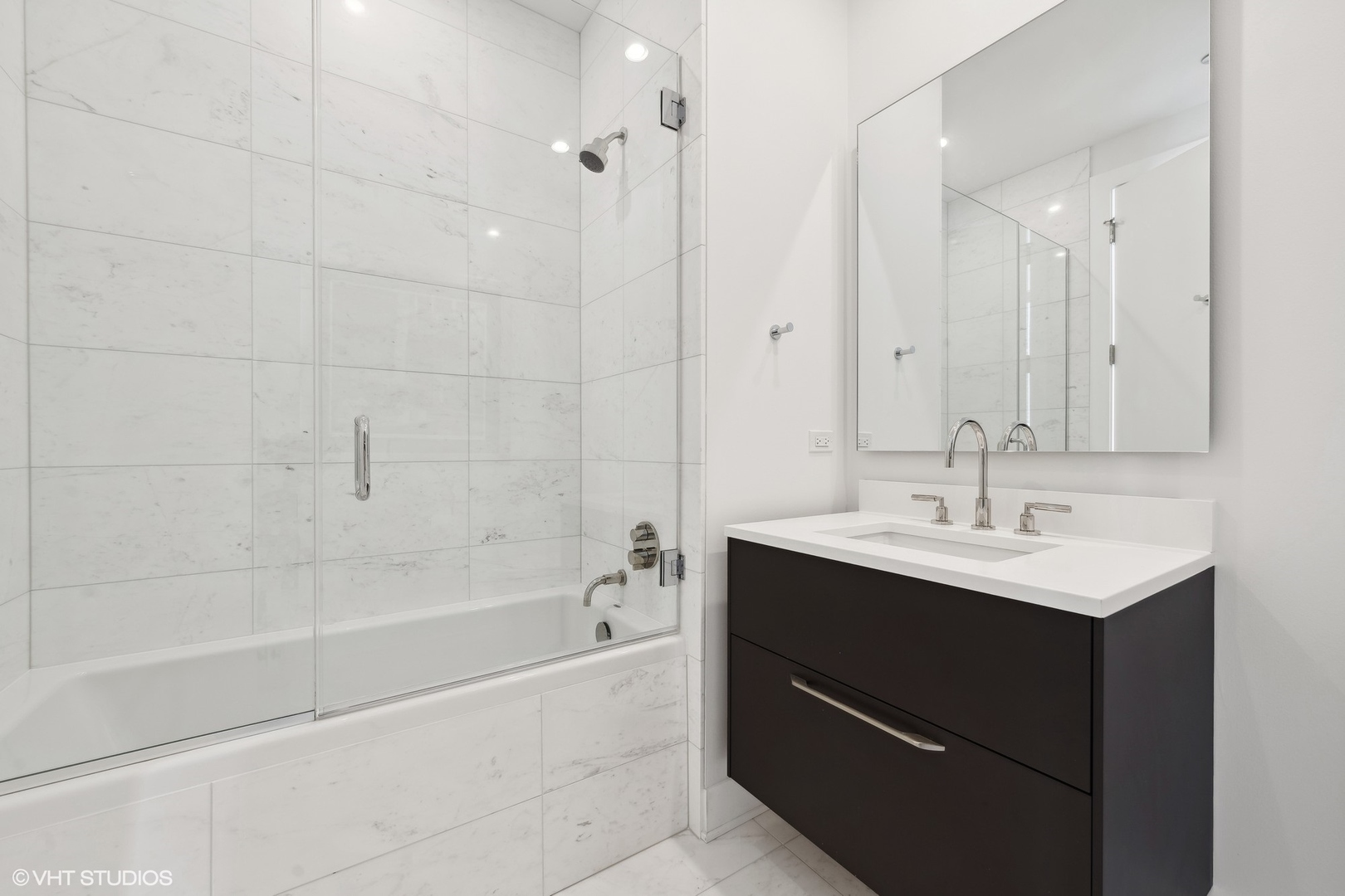 403 North Wabash Avenue, Unit 14A Chicago, IL 60611 - Photo 23 of 49 a bathroom with a bath tub sink mirror and shower