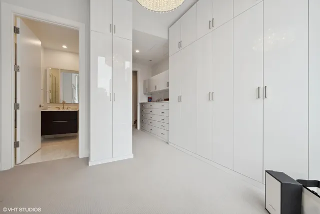 a view of a hallway with wooden cabinets