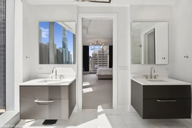 a en suite bathroom with a double vanity sink a mirror and a