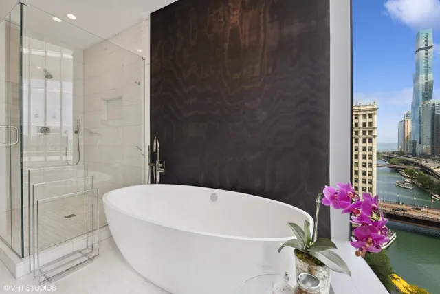 a white bath tub sitting next to a white toilet