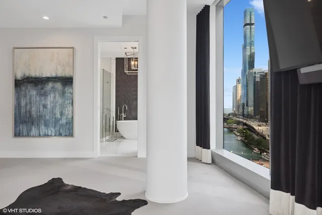 a view of a hallway with bathroom and front door