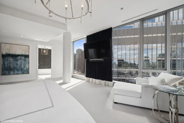 a living room with furniture windows and a flat screen tv