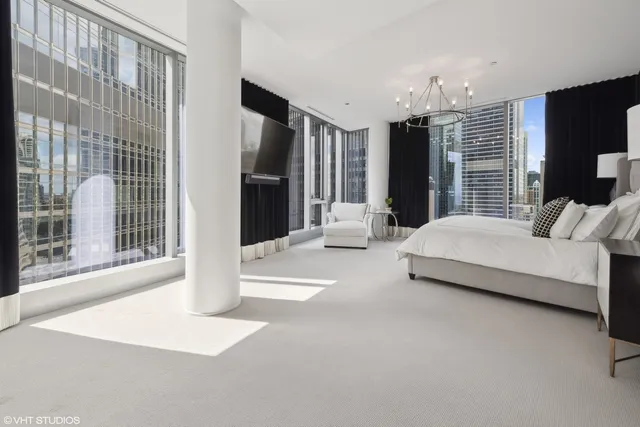 a spacious bedroom with a large bed and a large window