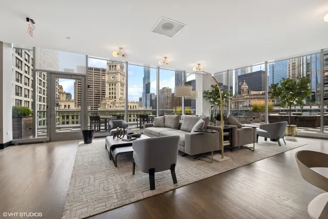 a living room with furniture and floor to ceiling windows