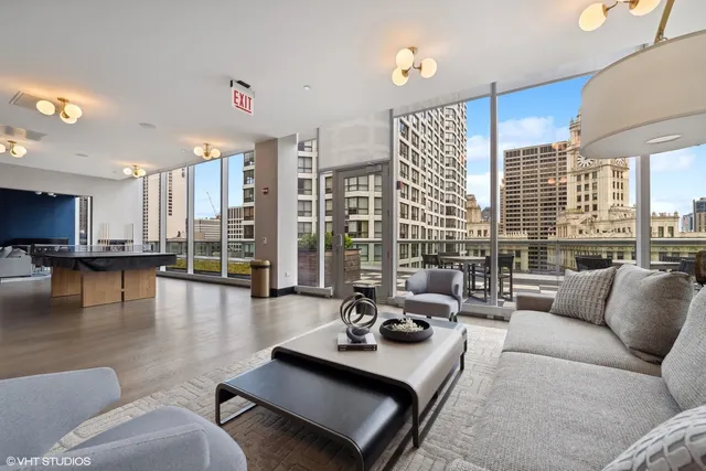 a living room with furniture a flat screen tv and a coffee table