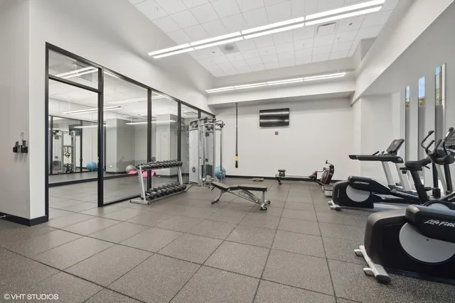 a view of a gym area with lots of furniture