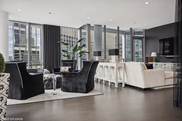 a living room with fireplace furniture and a large window