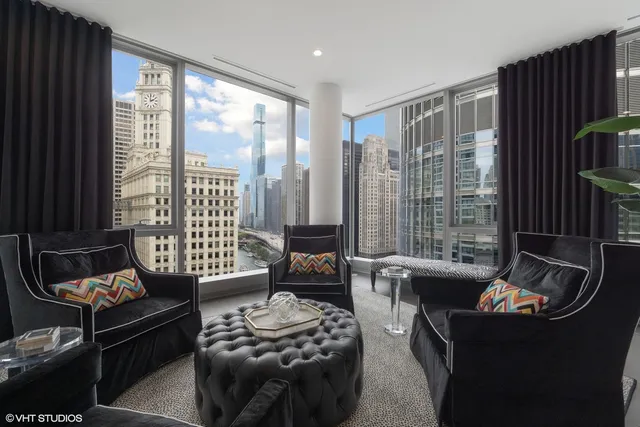 a living room with furniture and a floor to ceiling window