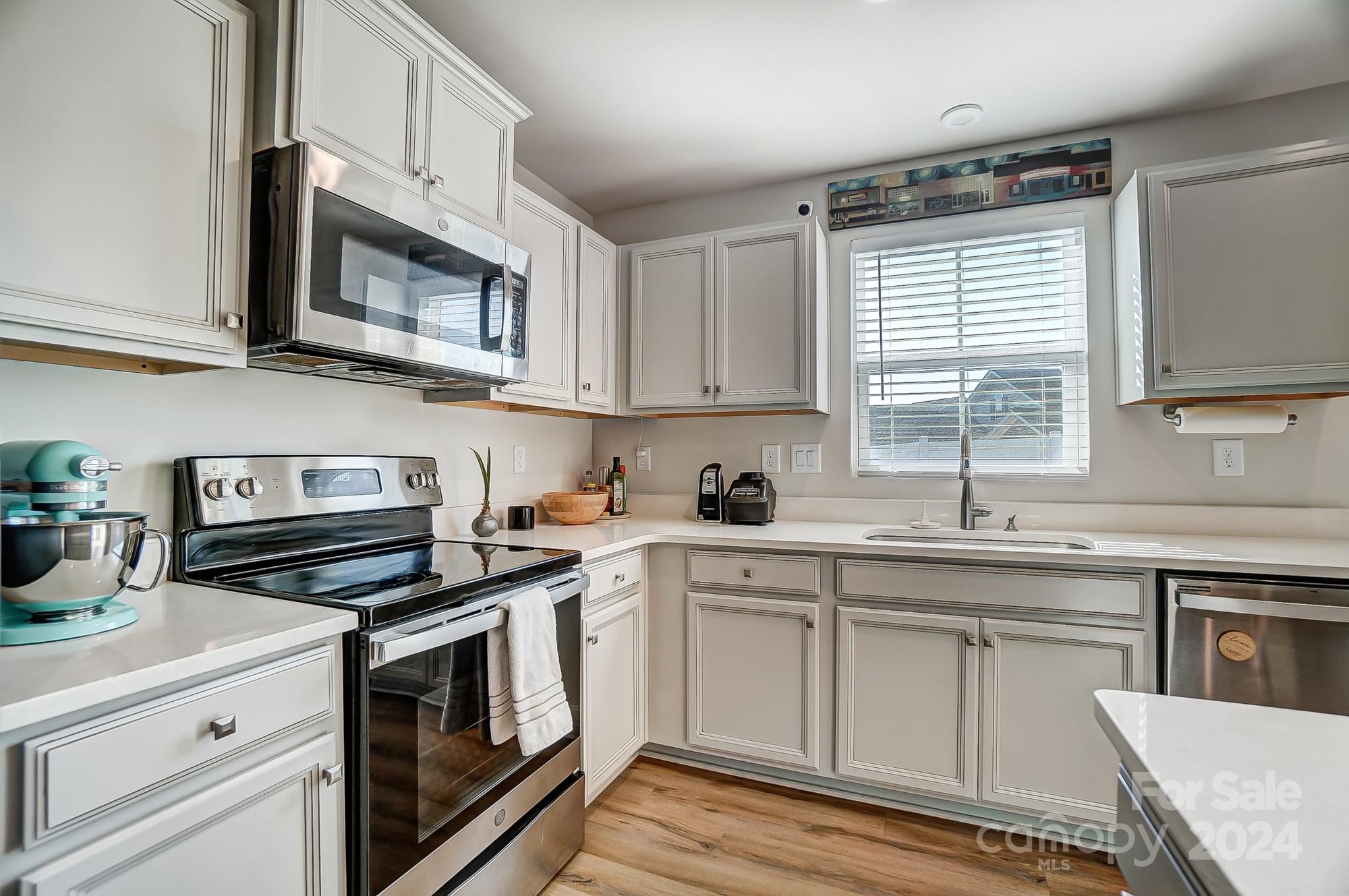 4136 Mackinnon Drive Charlotte, NC 28214 - Photo 13 of 48 a kitchen with cabinets stainless steel appliances a sink and a window