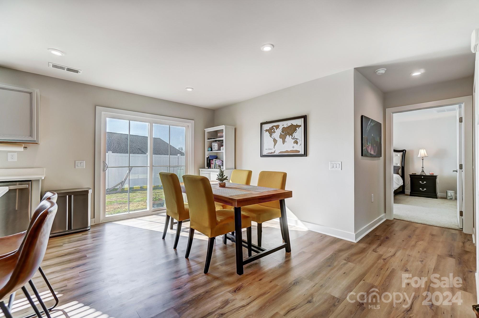 4136 Mackinnon Drive Charlotte, NC 28214 - Photo 15 of 48 a view of a dining room with furniture and wooden floor