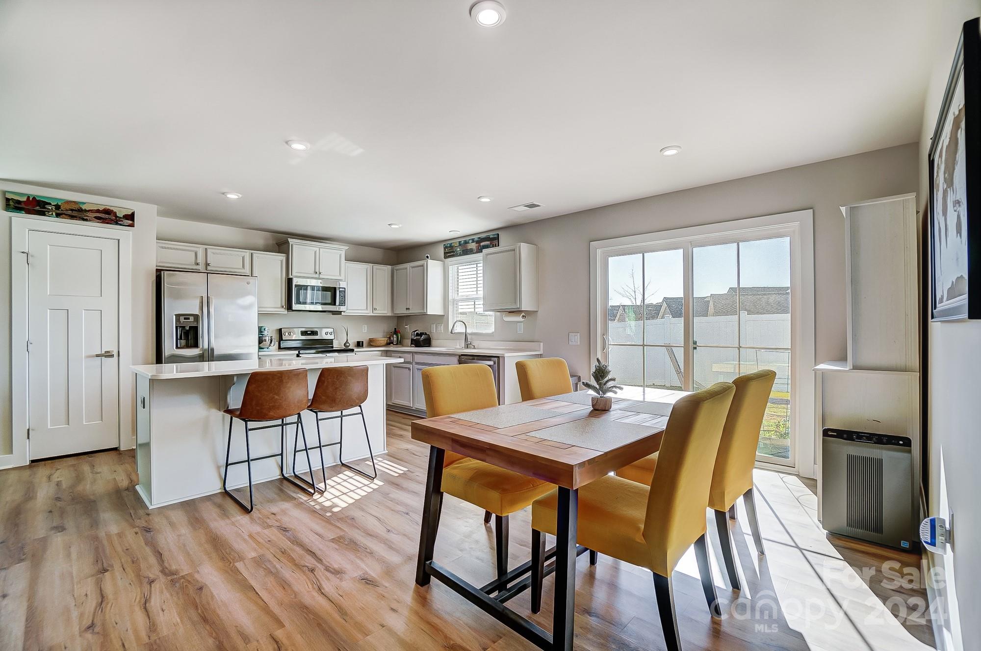 4136 Mackinnon Drive Charlotte, NC 28214 - Photo 16 of 48 a view of a dining room with furniture and wooden floor