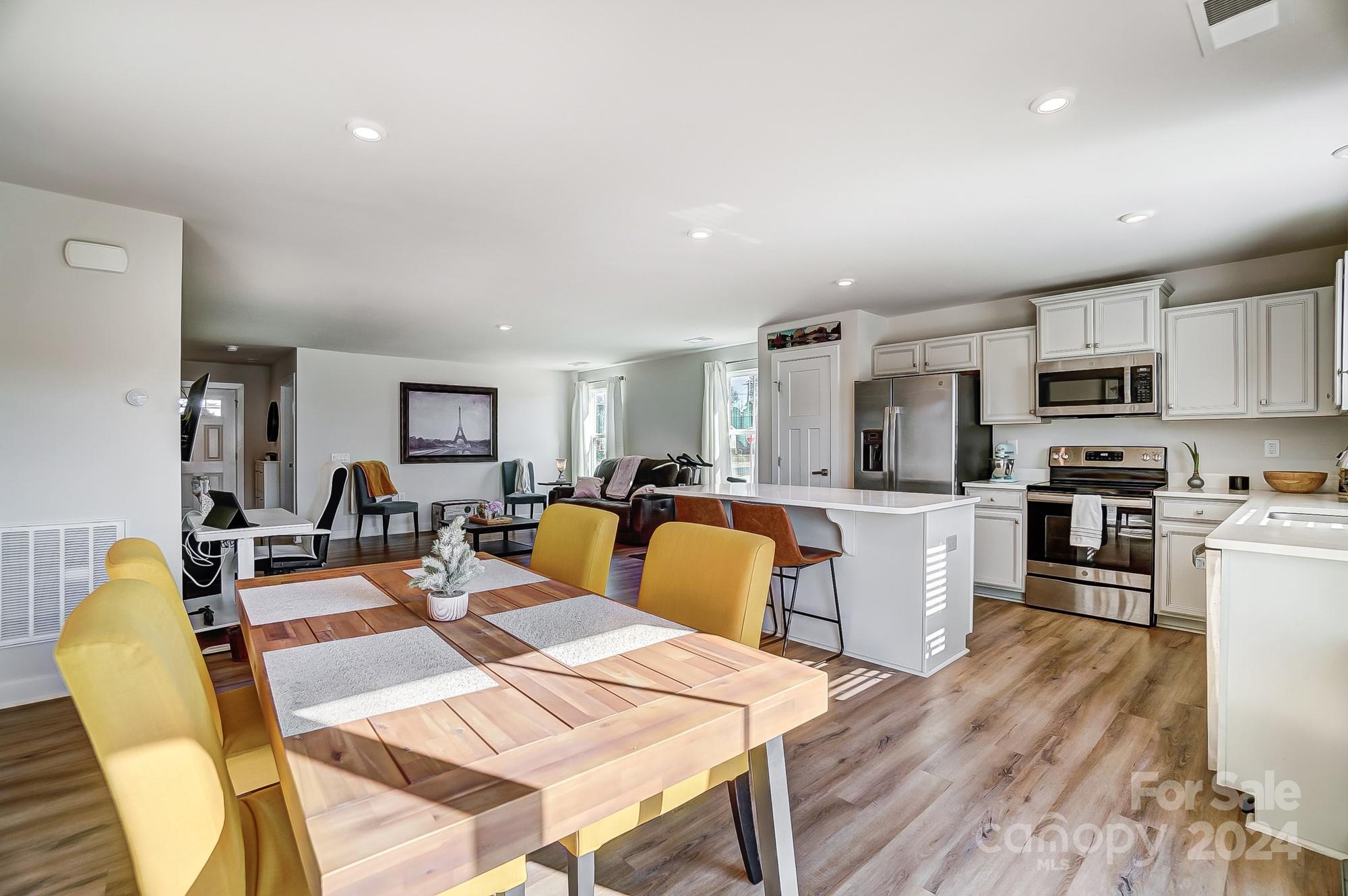 4136 Mackinnon Drive Charlotte, NC 28214 - Photo 18 of 48 a living room with stainless steel appliances furniture dining table and kitchen view