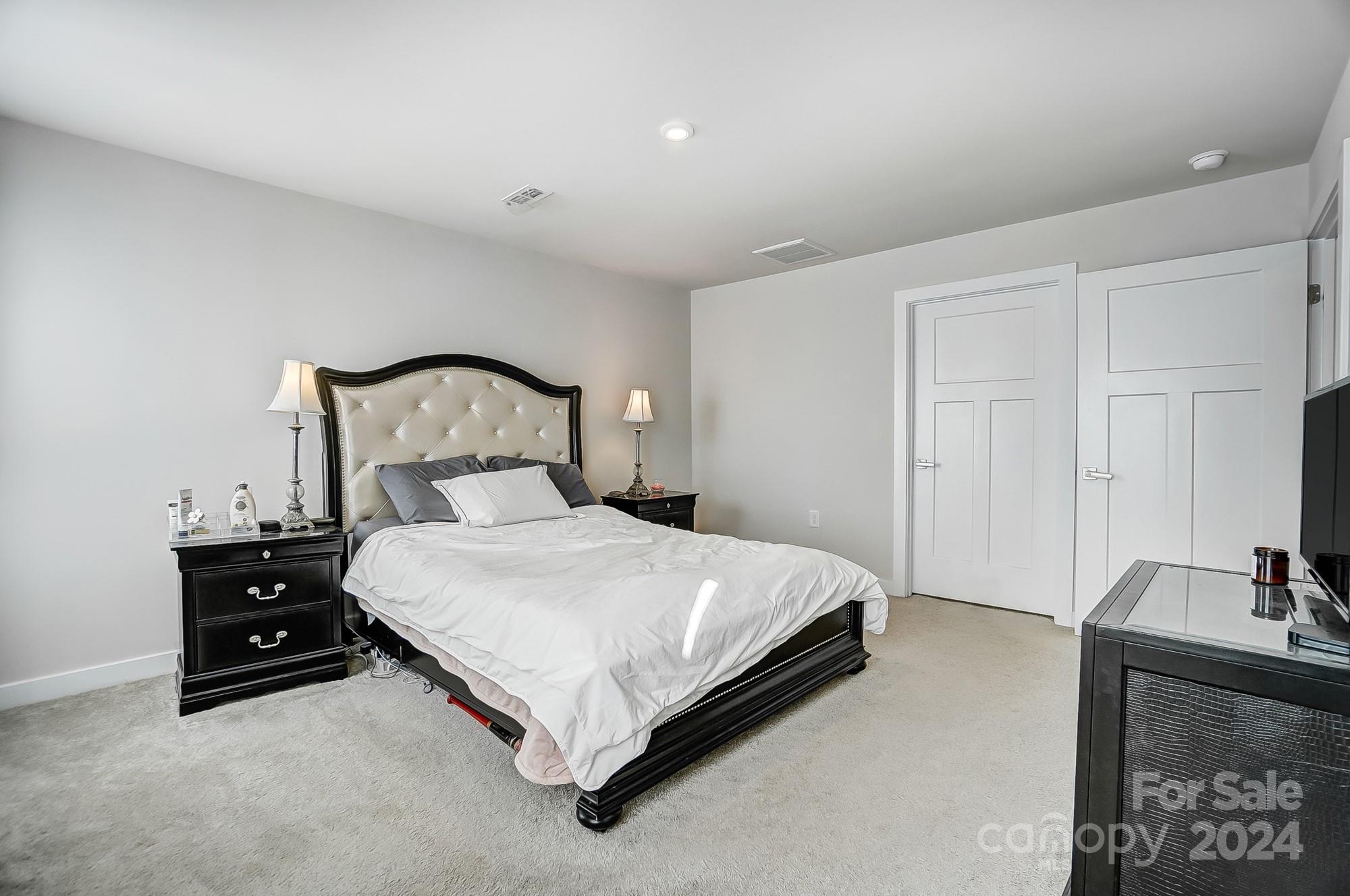4136 Mackinnon Drive Charlotte, NC 28214 - Photo 22 of 48 a bedroom with a bed and a lamp on dresser