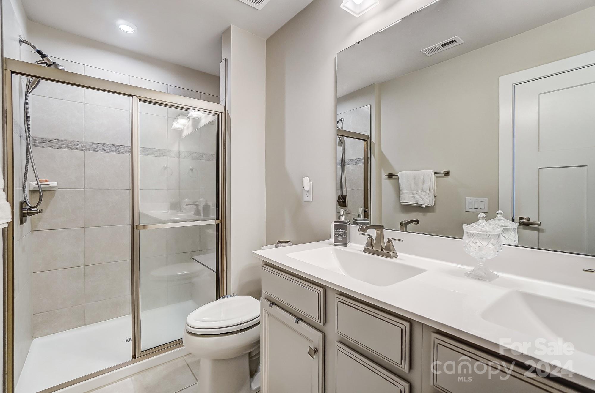 4136 Mackinnon Drive Charlotte, NC 28214 - Photo 23 of 48 a bathroom with a sink toilet and shower