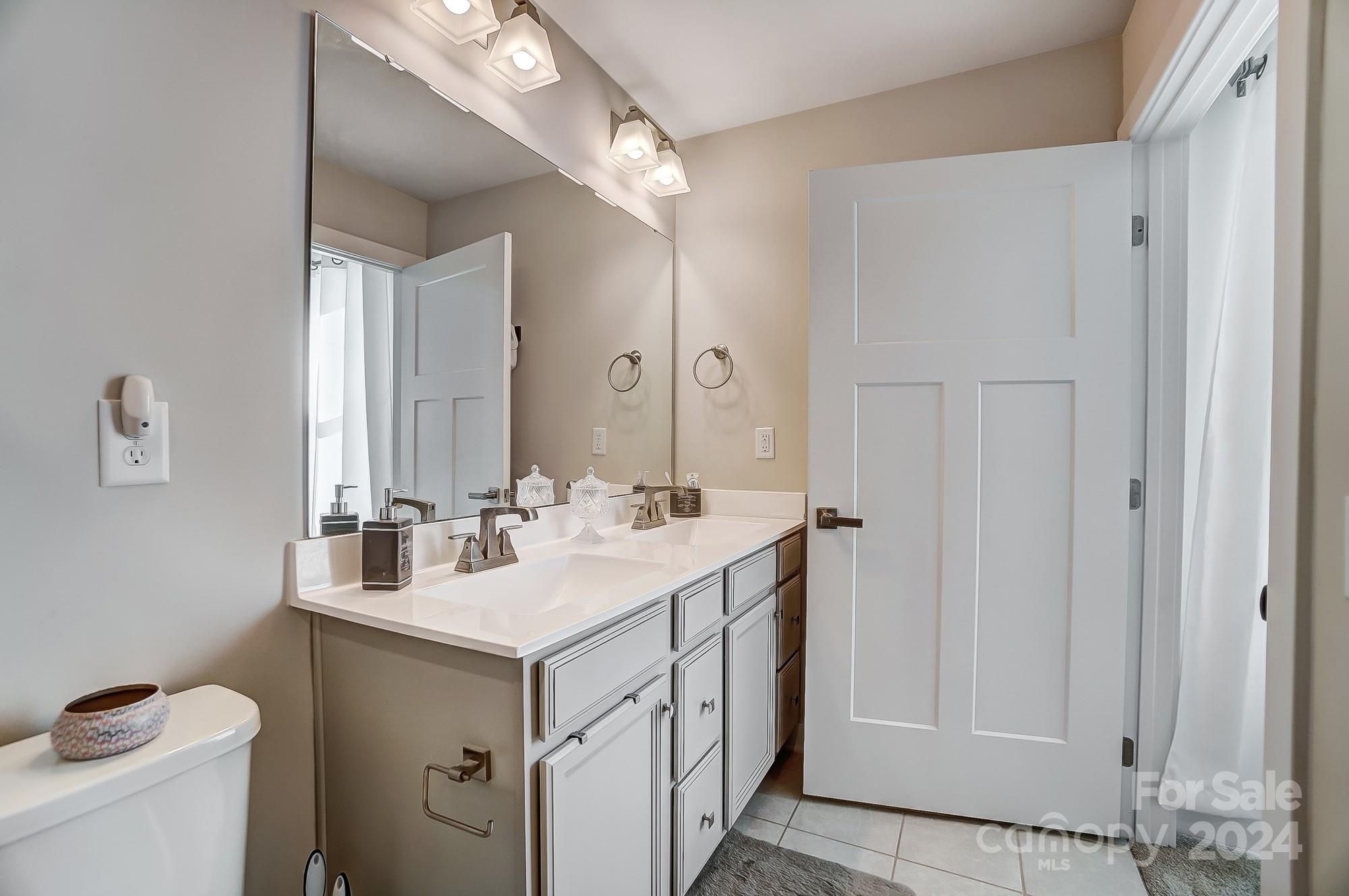 4136 Mackinnon Drive Charlotte, NC 28214 - Photo 24 of 48 a bathroom with a sink and a mirror