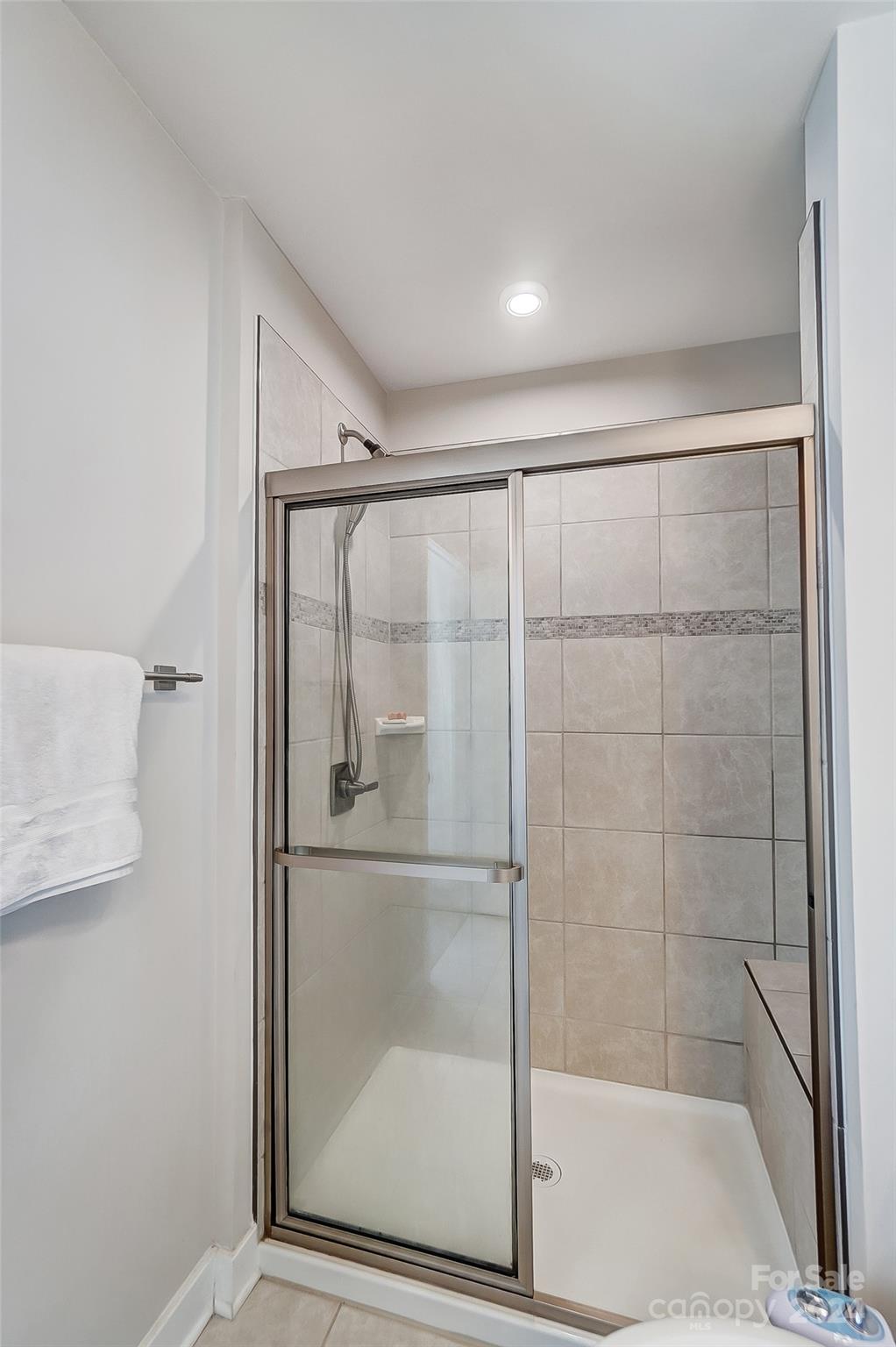 4136 Mackinnon Drive Charlotte, NC 28214 - Photo 26 of 48 a bathroom with a glass shower door