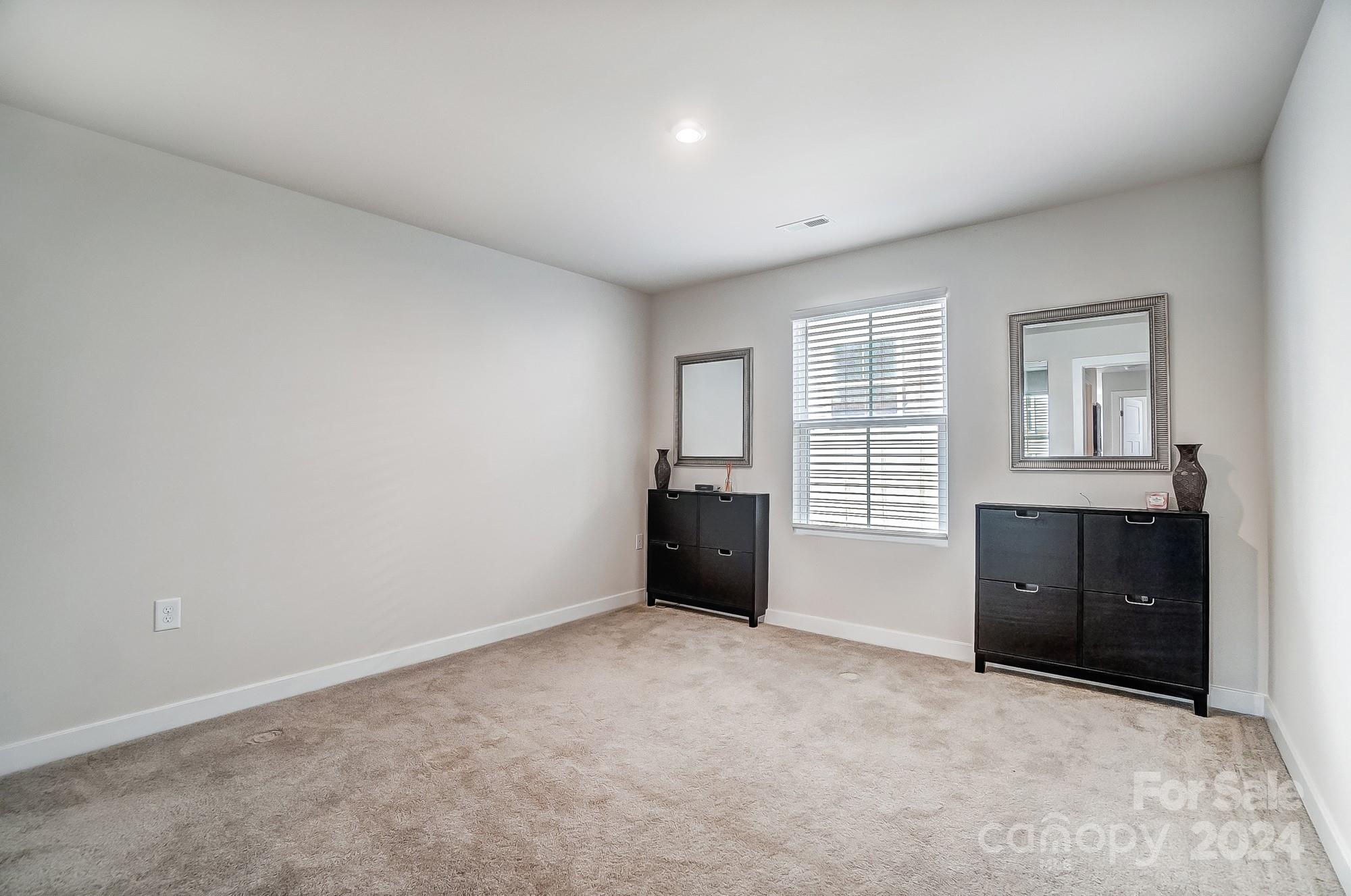 4136 Mackinnon Drive Charlotte, NC 28214 - Photo 27 of 48 an empty room with windows and closet