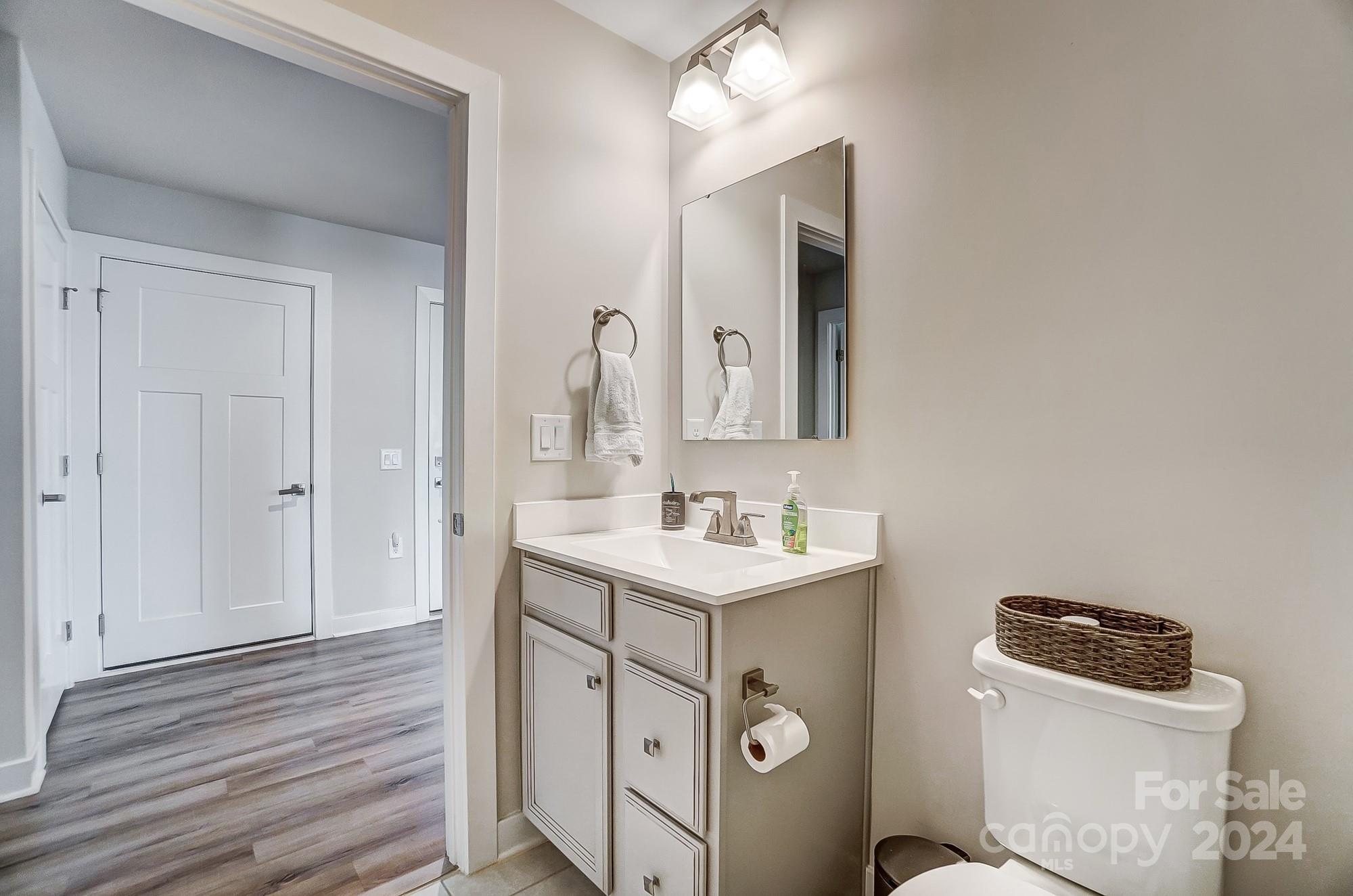 4136 Mackinnon Drive Charlotte, NC 28214 - Photo 32 of 48 a bathroom with a toilet sink and mirror