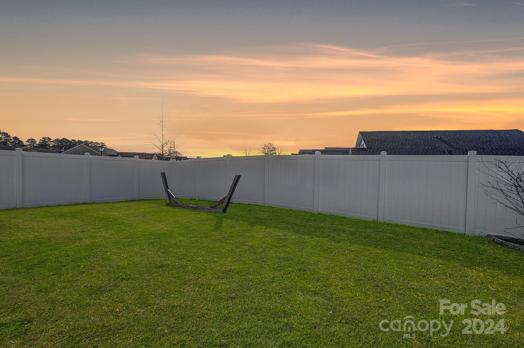 4136 Mackinnon Drive Charlotte, NC 28214 - Photo 40 of 48 a backyard of a house with lots of green space