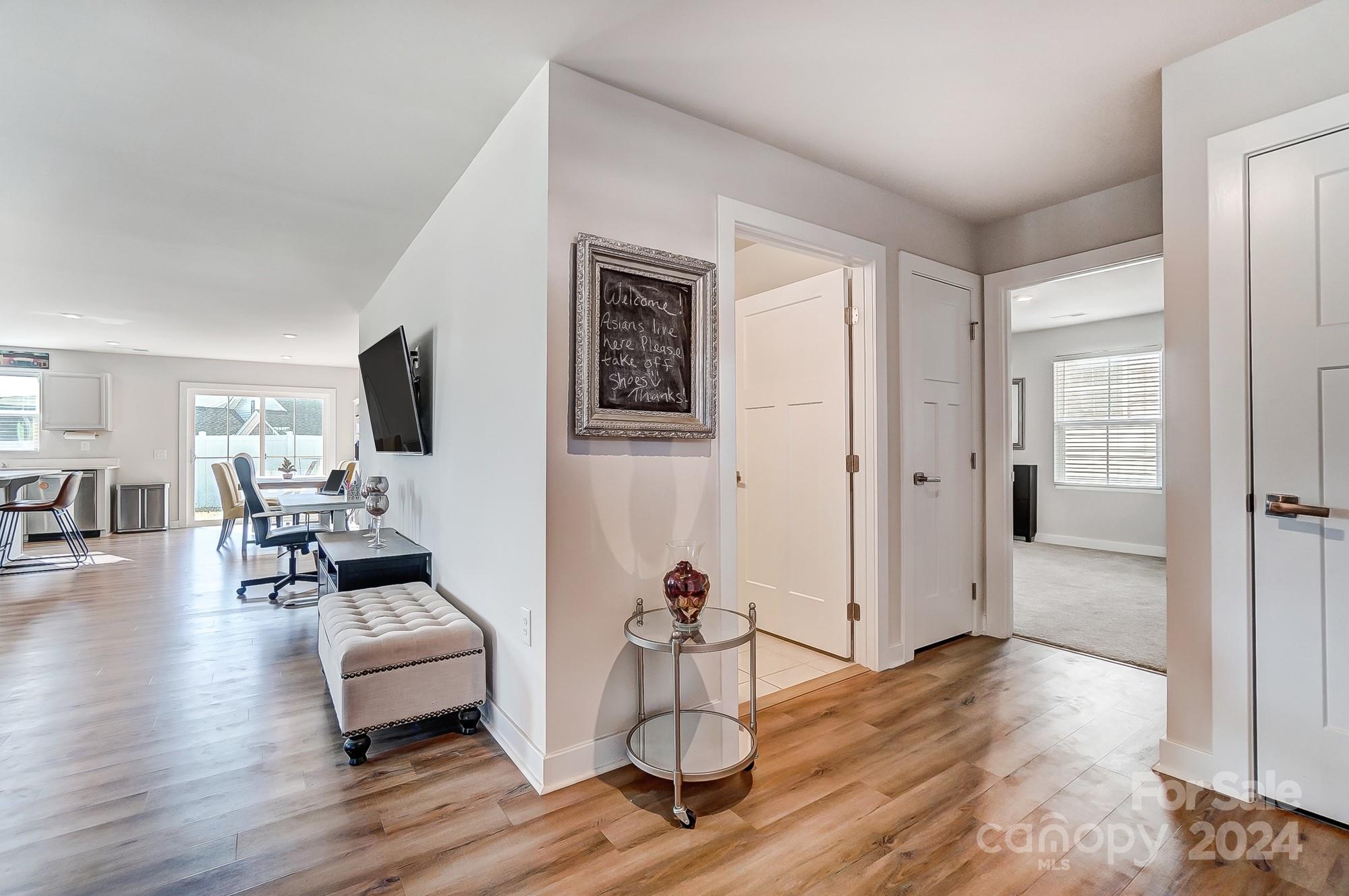 4136 Mackinnon Drive Charlotte, NC 28214 - Photo 4 of 48 a living room with furniture a flat screen tv and a wooden floor