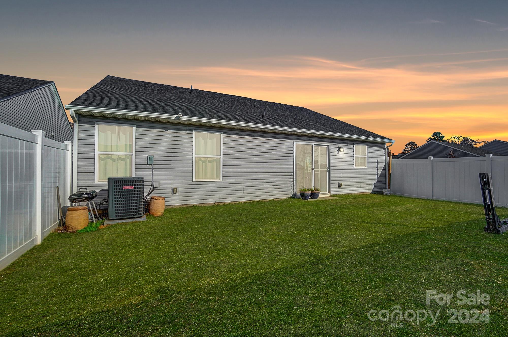 4136 Mackinnon Drive Charlotte, NC 28214 - Photo 42 of 48 a backyard of a house with table and chairs