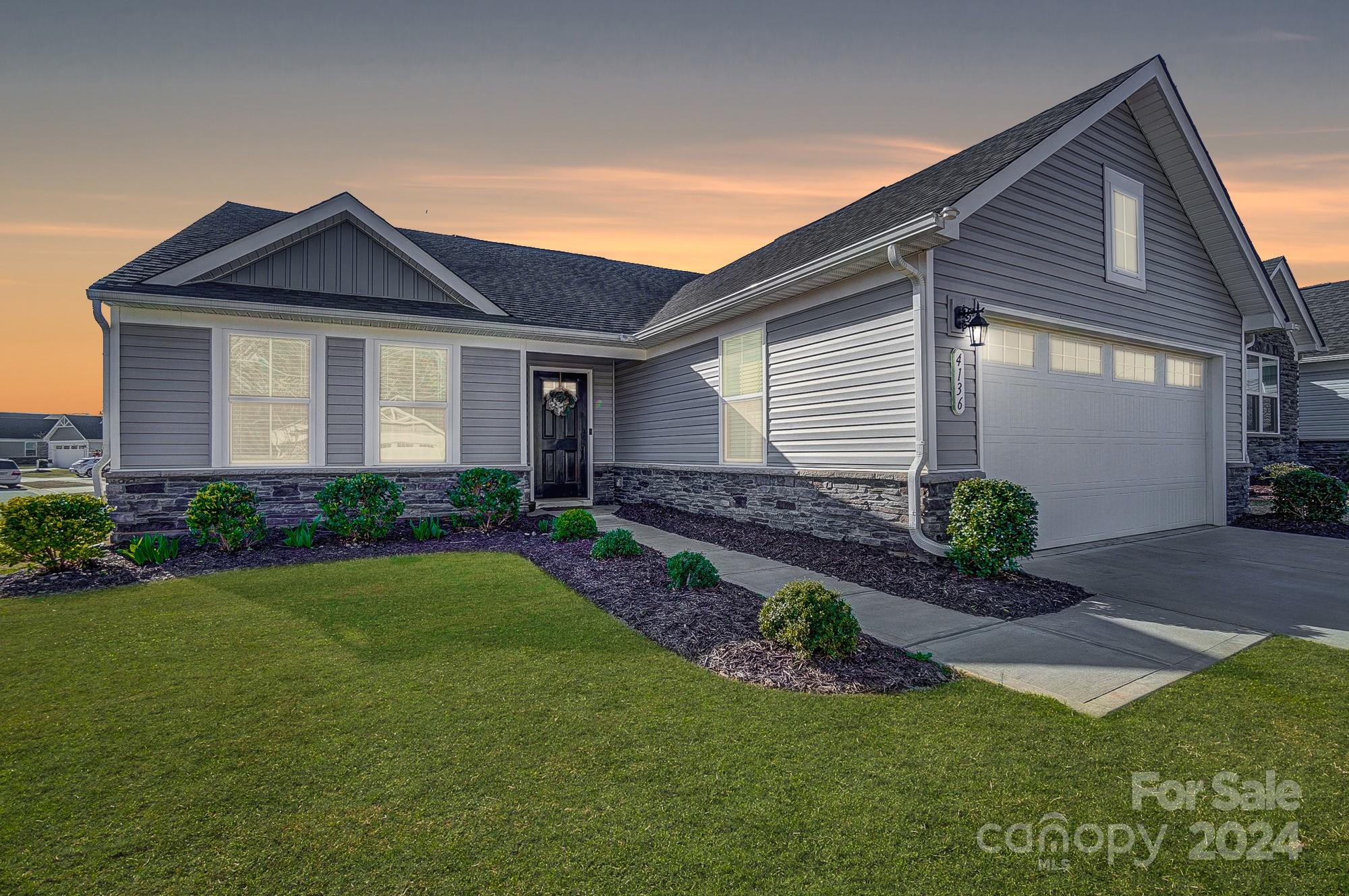 4136 Mackinnon Drive Charlotte, NC 28214 - Photo 46 of 48 a front view of a house with a yard and potted plants