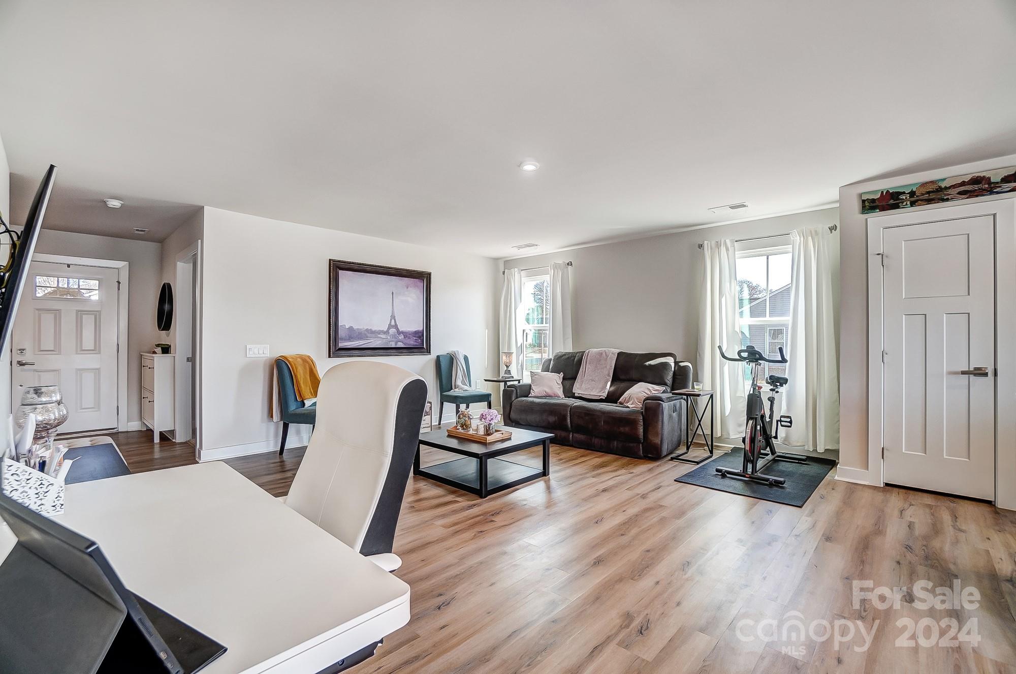 4136 Mackinnon Drive Charlotte, NC 28214 - Photo 6 of 48 a living room with furniture a wooden floor and next to a window