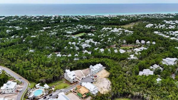 an aerial view of a house with yard swimming pool and mountain view