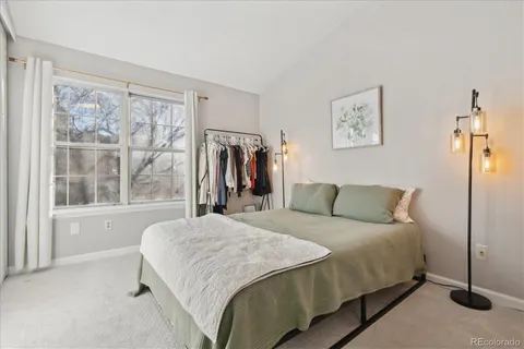 a bedroom with a bed and a large window