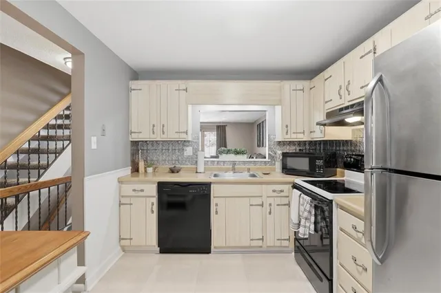 a kitchen with a sink stove and cabinets