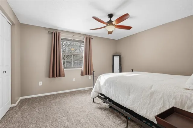 a bedroom with a large bed and a window