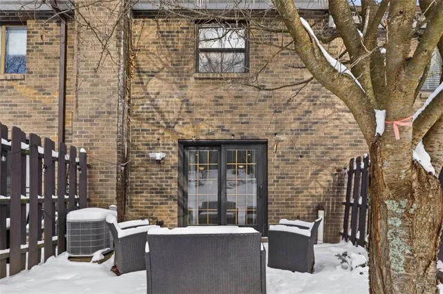 a brick building with a bench in front of it