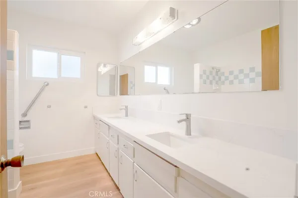 a bathroom with a sink a mirror and shower