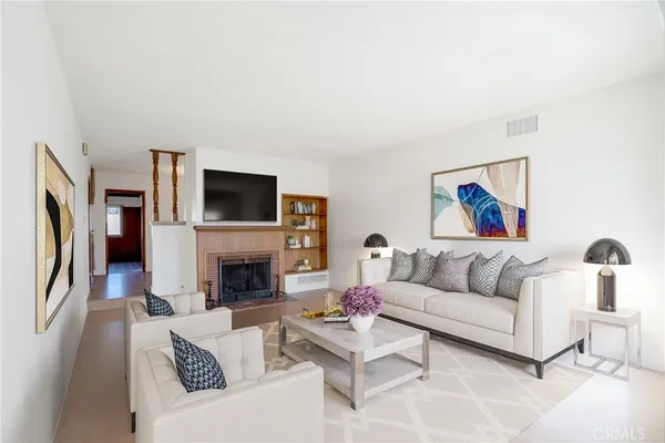 a living room with furniture a fireplace and a flat screen tv