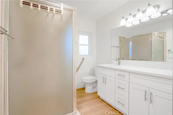 a spacious bathroom with a toilet sink and mirror