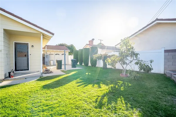 a view of a house with a yard and sitting area