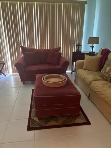 a living room with furniture and a lamp