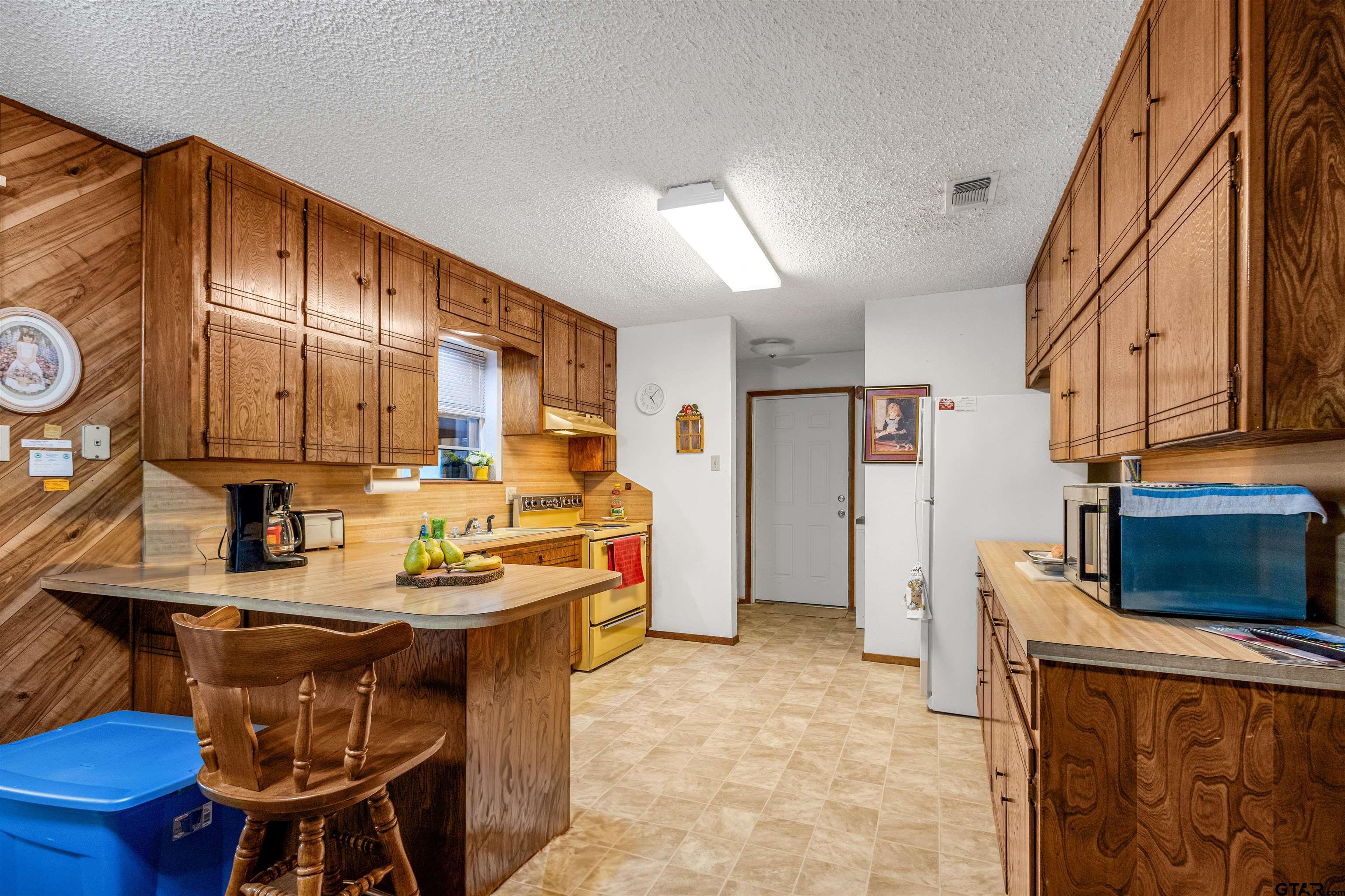 3702 E Highway Quitman, TX 75783 - Photo 12 of 33 a kitchen with a sink a stove and a refrigerator