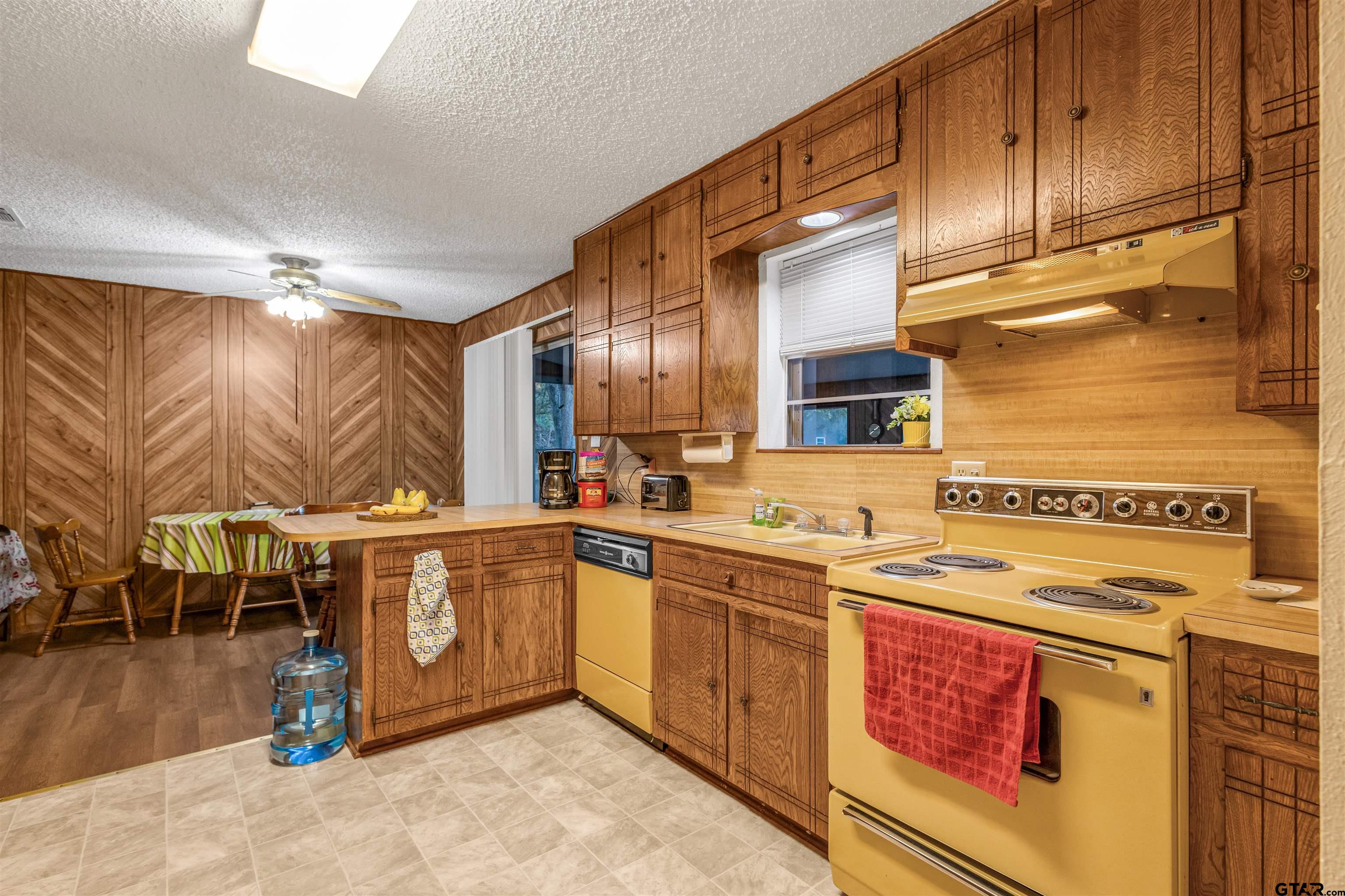 3702 E Highway Quitman, TX 75783 - Photo 13 of 33 a kitchen with stainless steel appliances granite countertop a stove a sink and a microwave