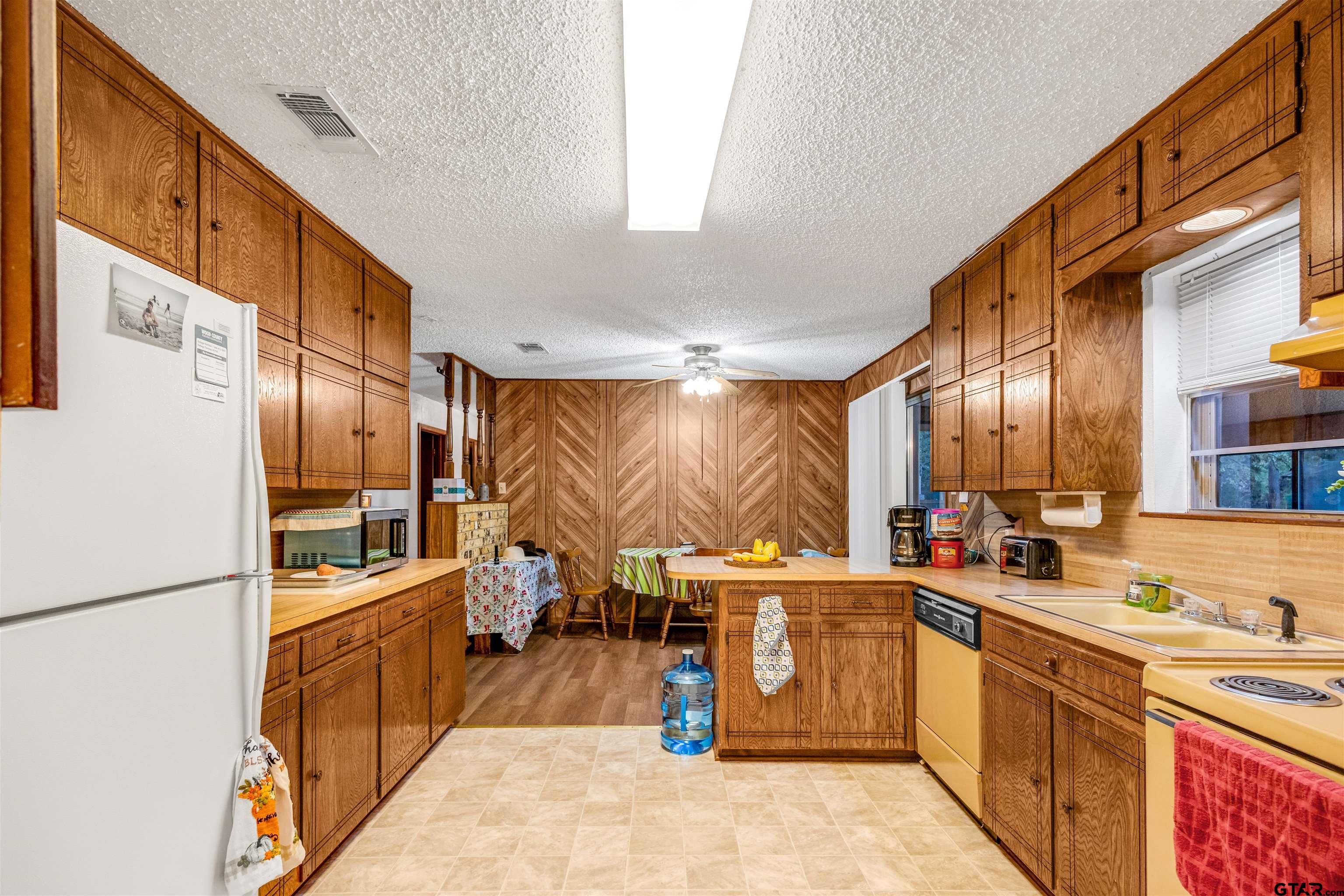 3702 E Highway Quitman, TX 75783 - Photo 14 of 33 a kitchen with a sink refrigerator and cabinets