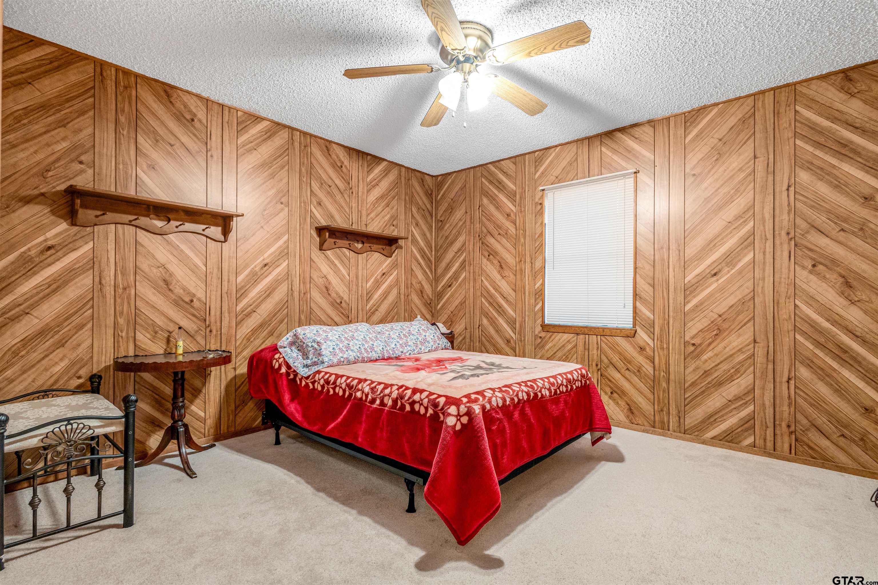 3702 E Highway Quitman, TX 75783 - Photo 20 of 33 a bedroom with a bed and a chandelier