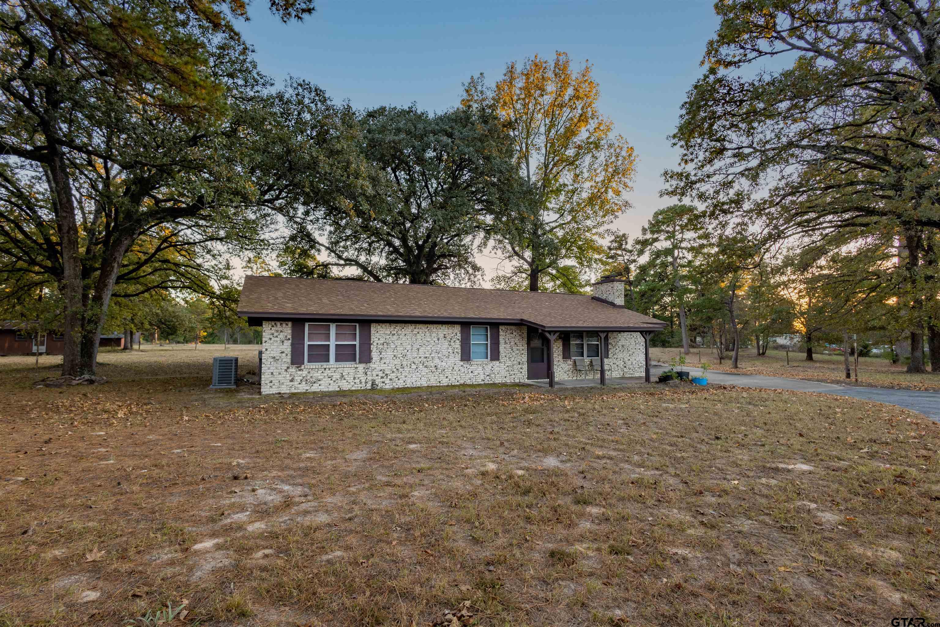 3702 E Highway Quitman, TX 75783 - Photo 2 of 33 a house that has a tree in front of it