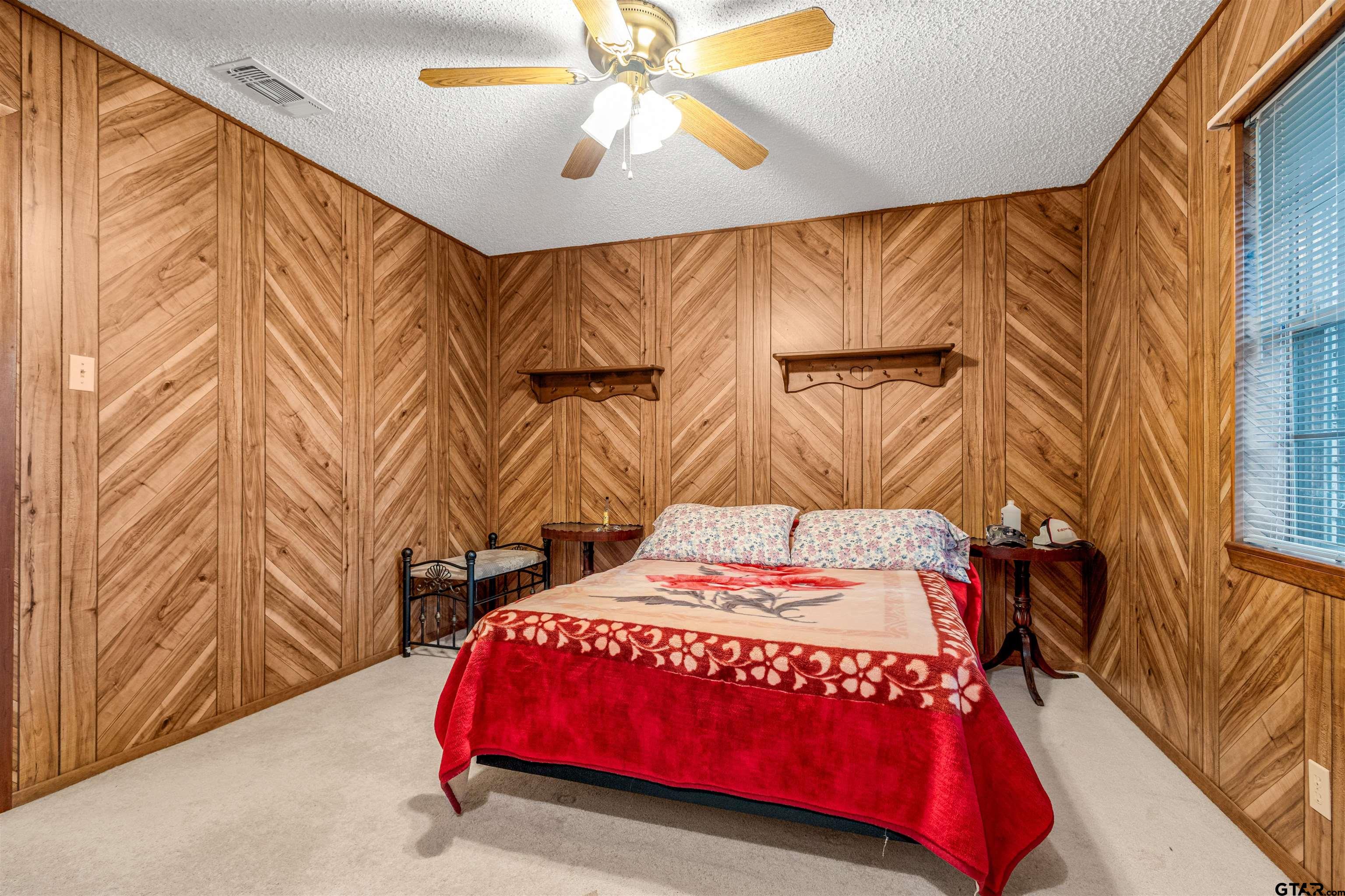 3702 E Highway Quitman, TX 75783 - Photo 22 of 33 a bedroom with a bed and a chandelier