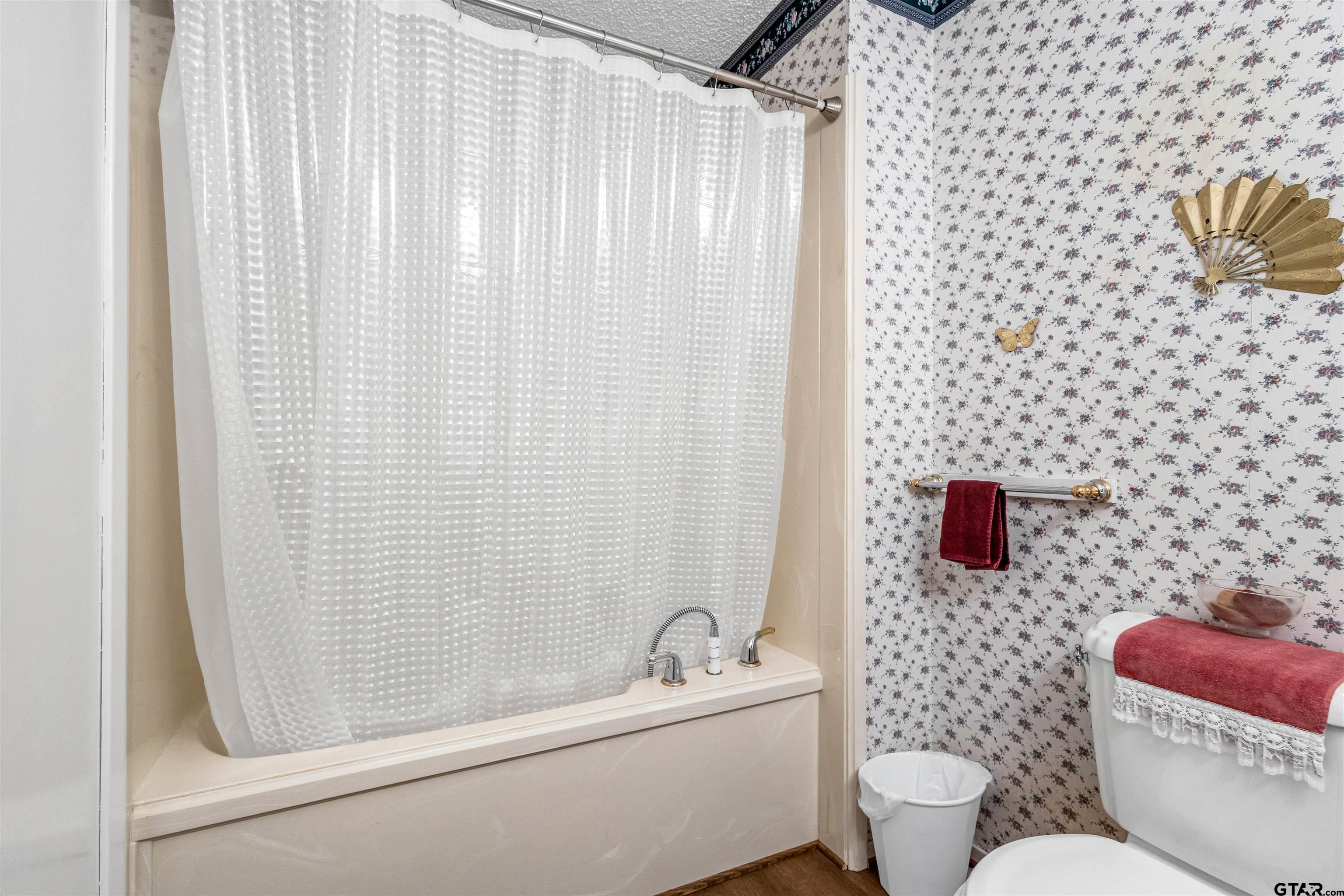 3702 E Highway Quitman, TX 75783 - Photo 23 of 33 a bathroom with a toilet and a shower curtain