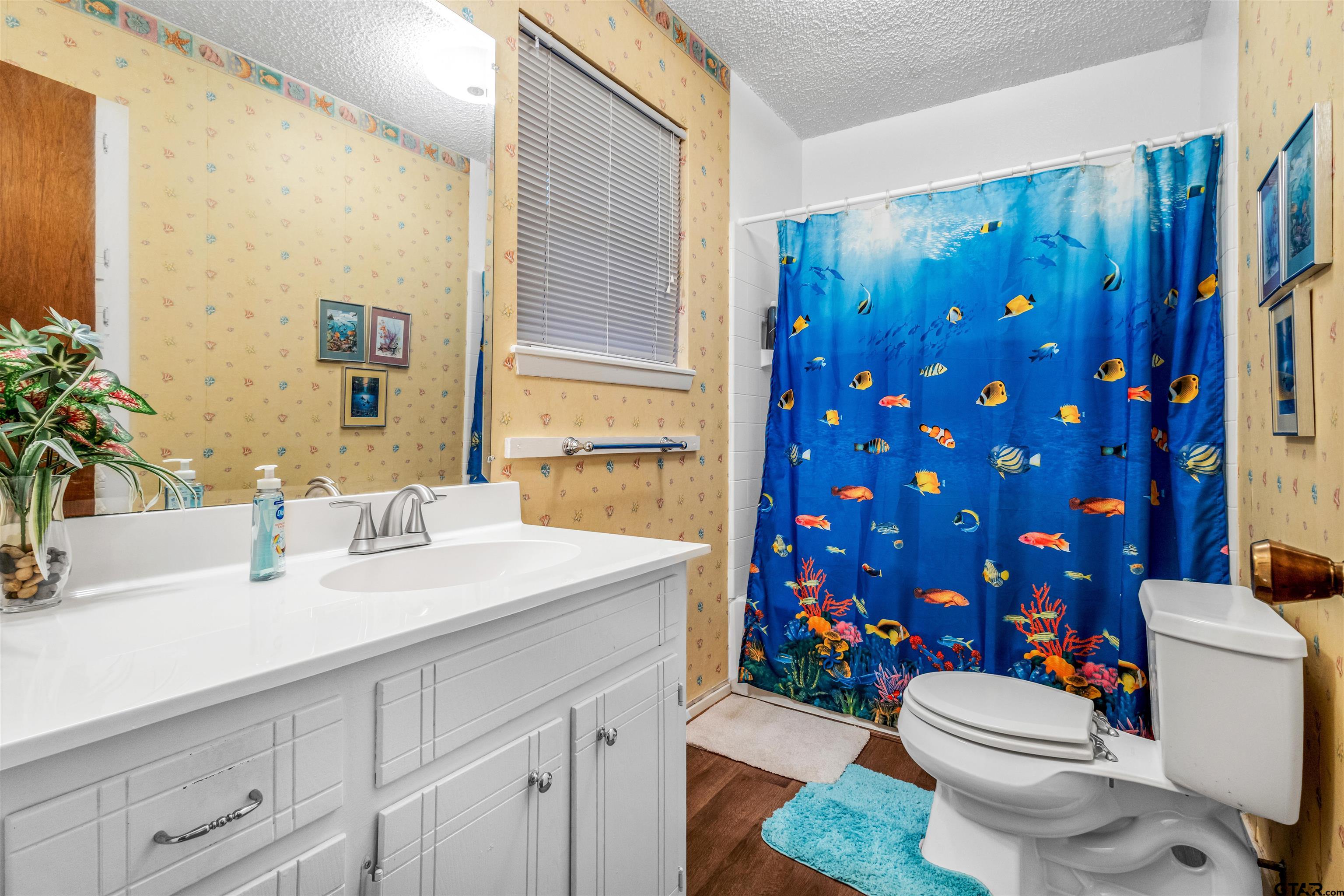 3702 E Highway Quitman, TX 75783 - Photo 29 of 33 a bathroom with a sink a toilet and shower curtain