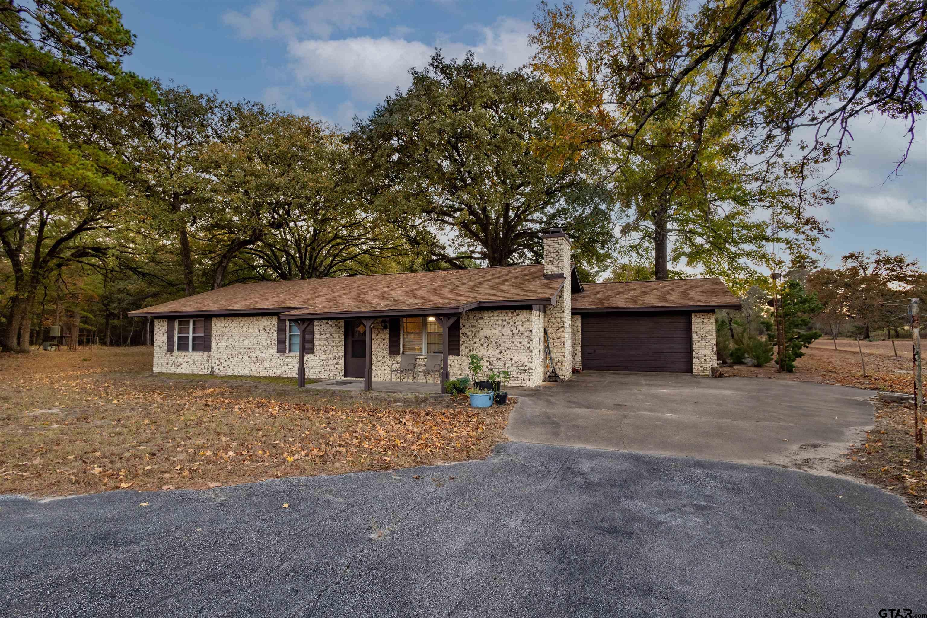 3702 E Highway Quitman, TX 75783 - Photo 4 of 33 a front view of a house with a yard and garage