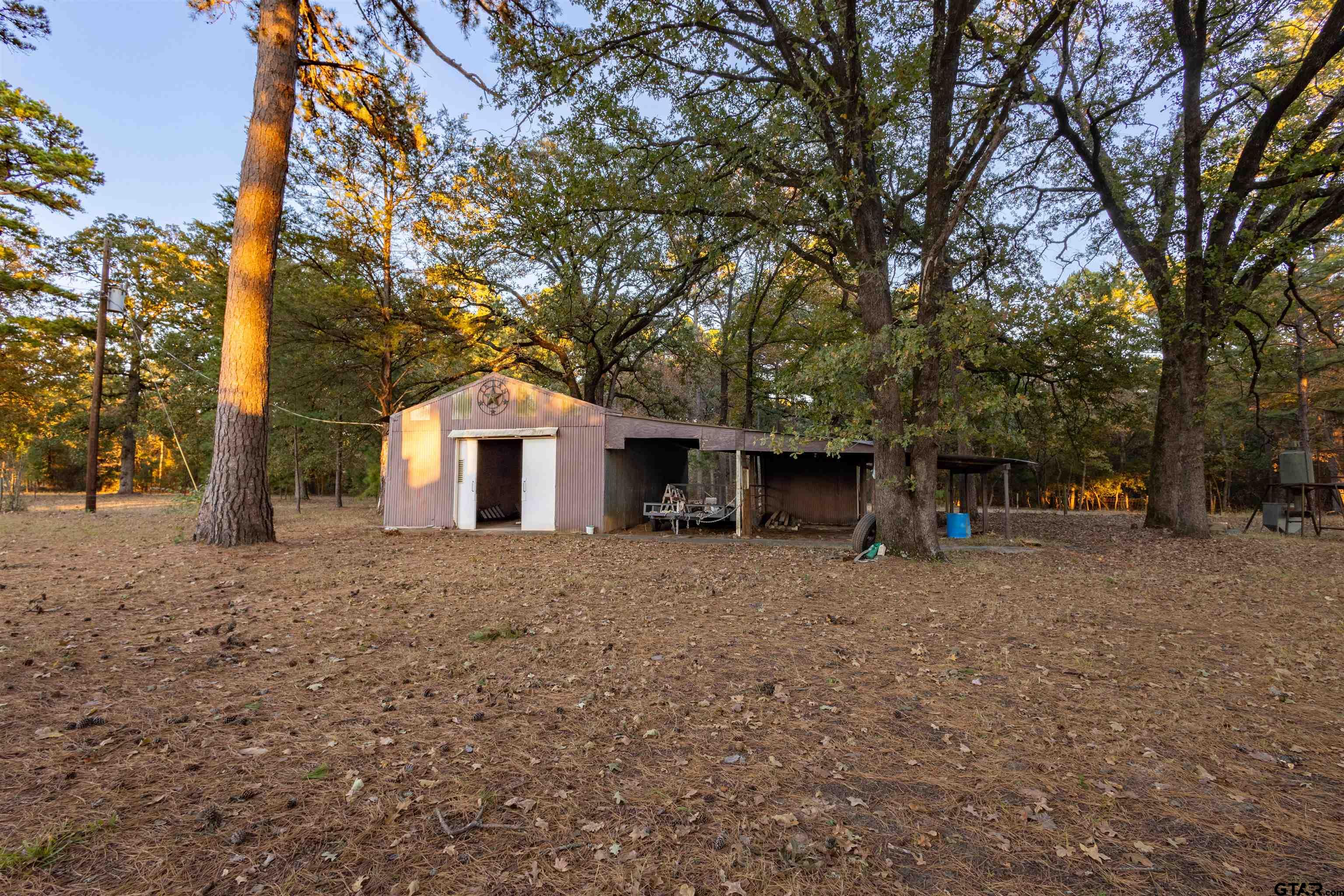 3702 E Highway Quitman, TX 75783 - Photo 5 of 33 a house with trees in front of it